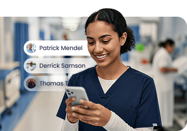 Nurse reviewing assigned patients on Nurse Mobile in a hospital hallway
